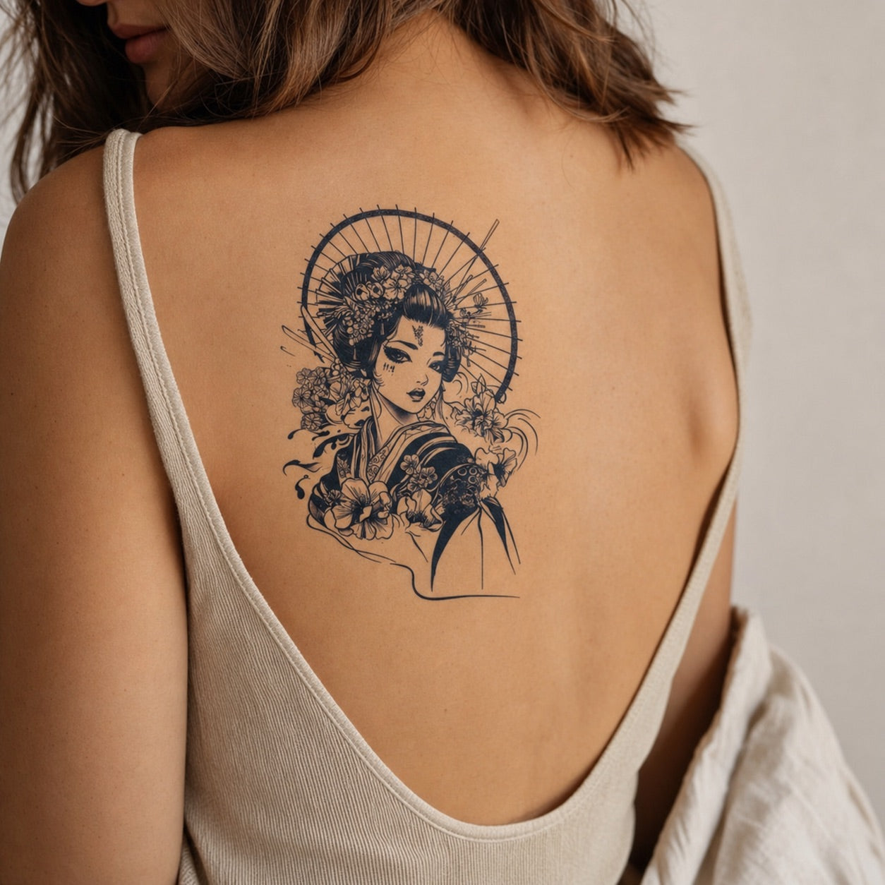Japanese geisha temporary tattoo with wagasa umbrella and cherry blossoms, detailed illustrative style on white background.