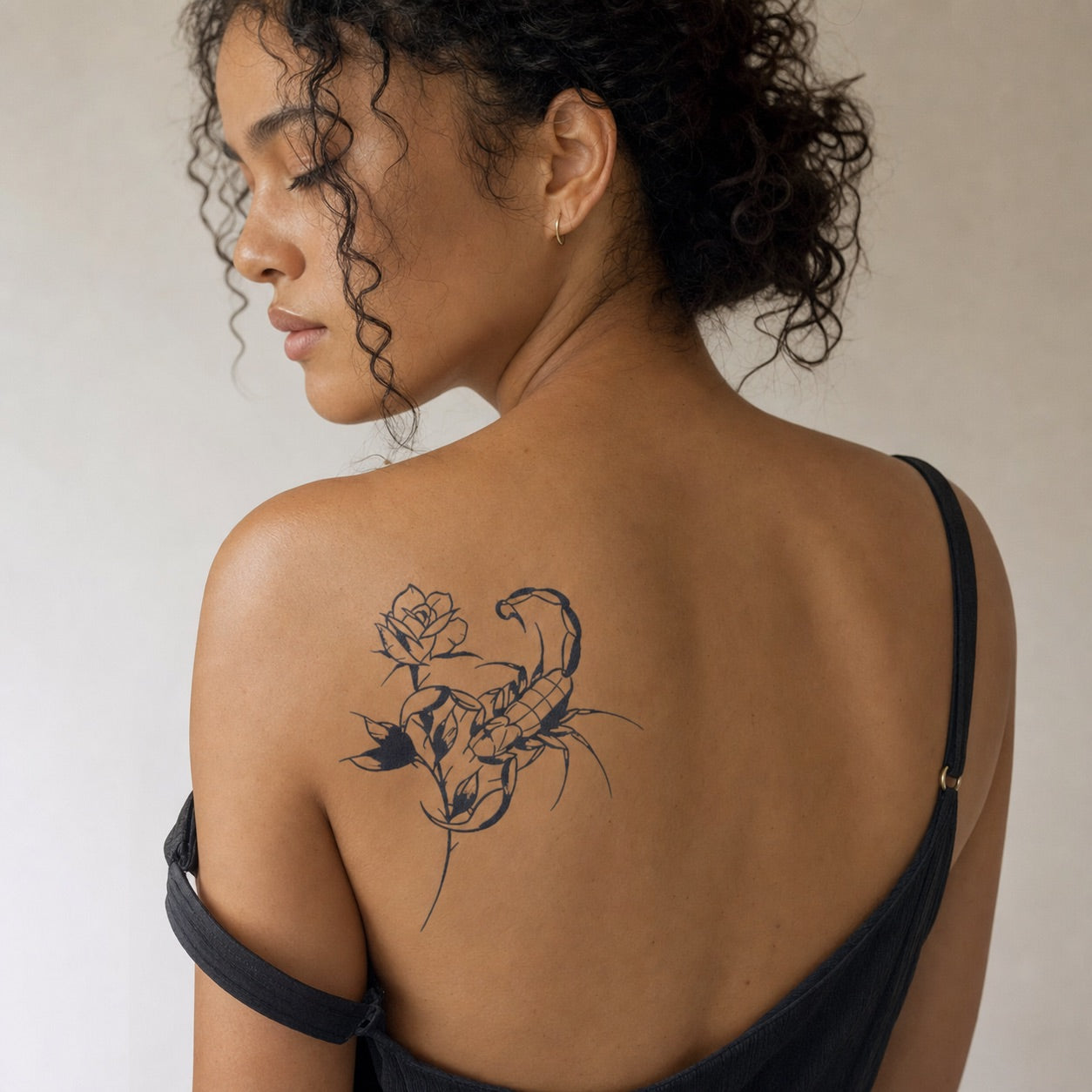 Scorpion and rose illustrative temporary tattoo, bold linework with solid black fills on white background.