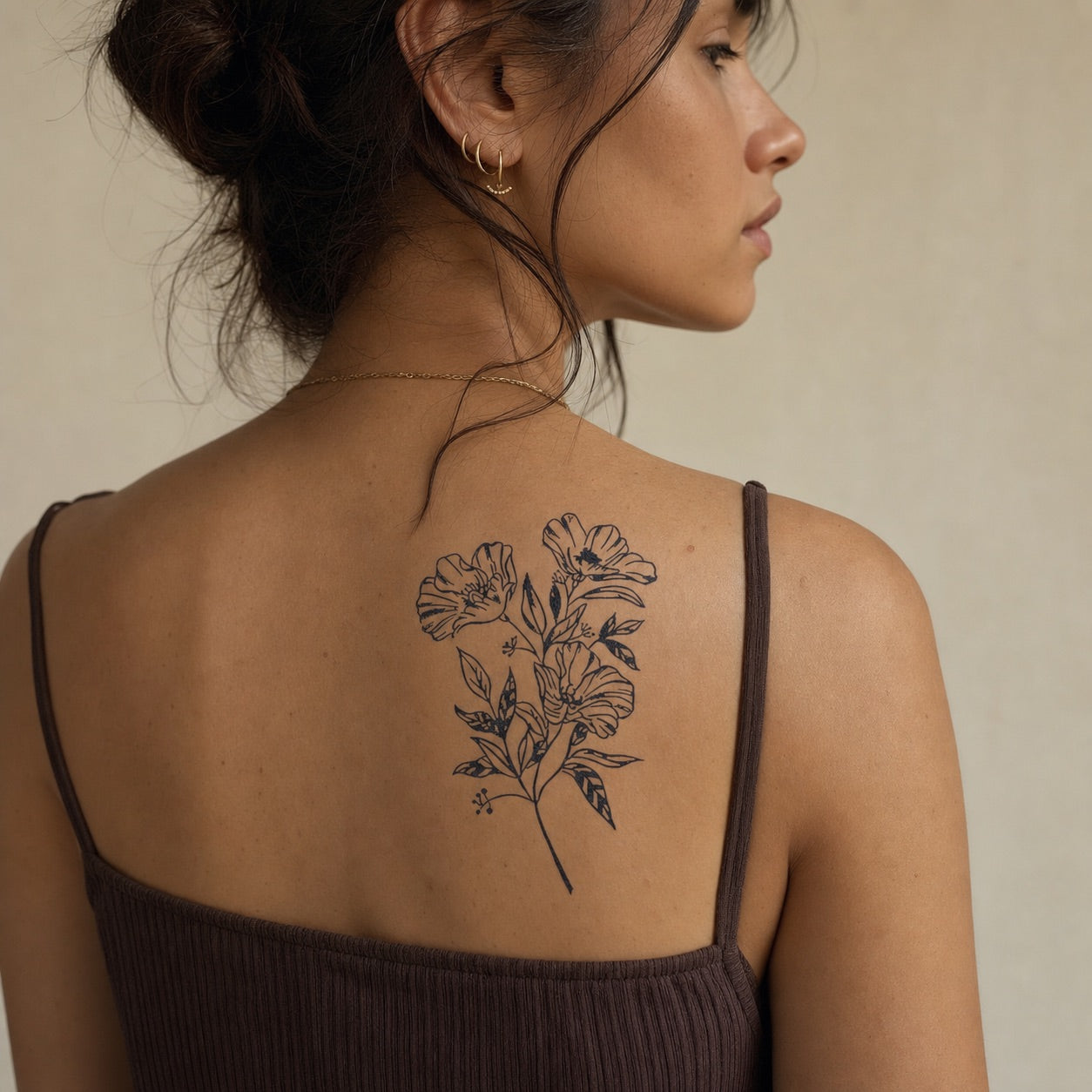Wild poppy bouquet temporary tattoo, three open blooms on a branching stem in loose linework on white background.