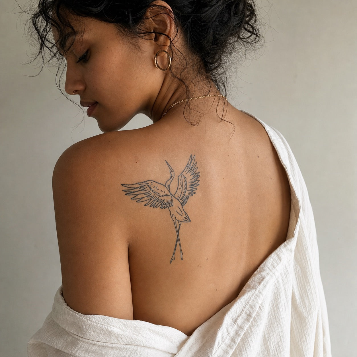 Japanese-style dancing crane temporary tattoo with wings fully spread, detailed linework on white background.