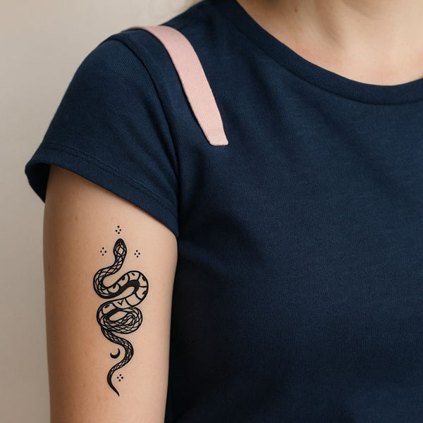 Coiled serpent tattoo with crescent moons in blue-black jagua ink
