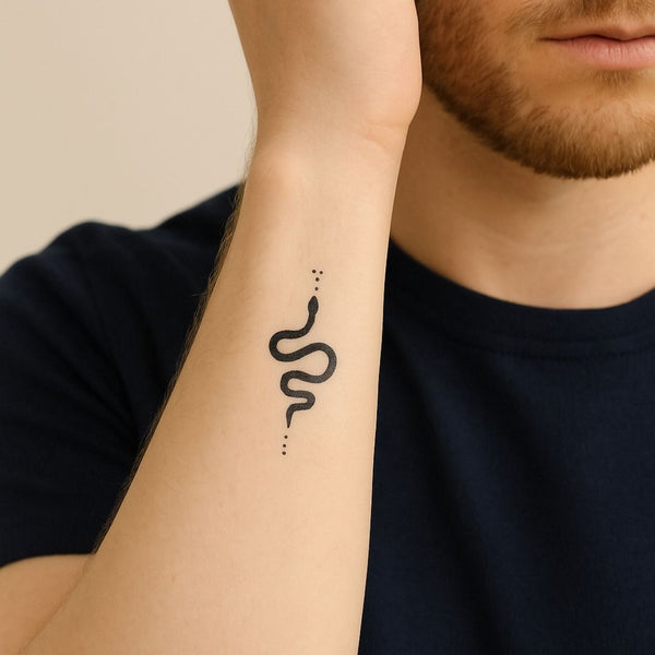 Minimalist single-line snake tattoo with dots, blue-black jagua ink