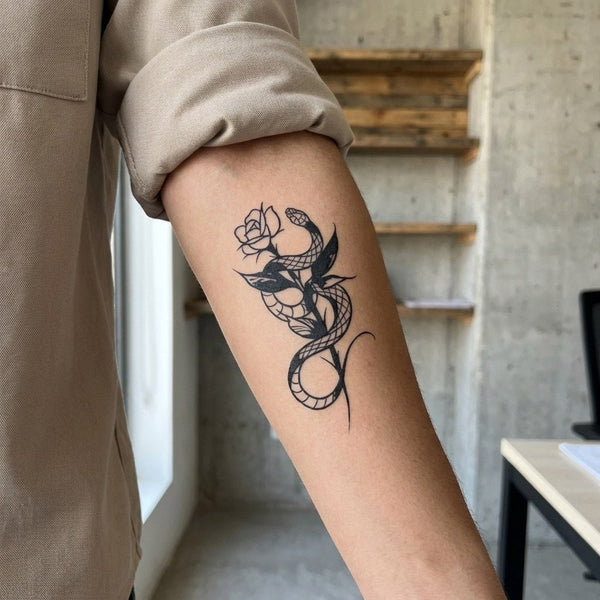 Snake coiled around a rose stem, temporary tattoo in blue-black jagua ink
